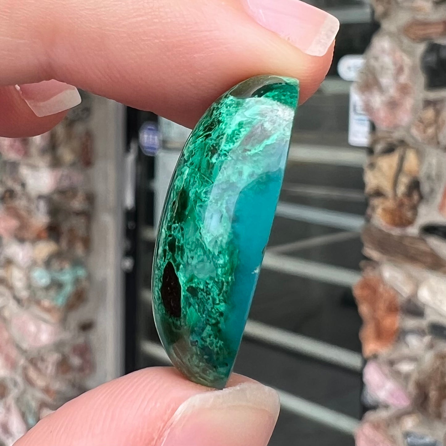 A loose, oval cabochon cut maw sit sit jade stone.