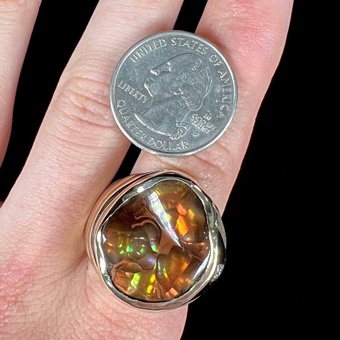 A men's heavy yellow gold ring set with a Mexican fire agate stone and three round brilliant cut diamond accents.