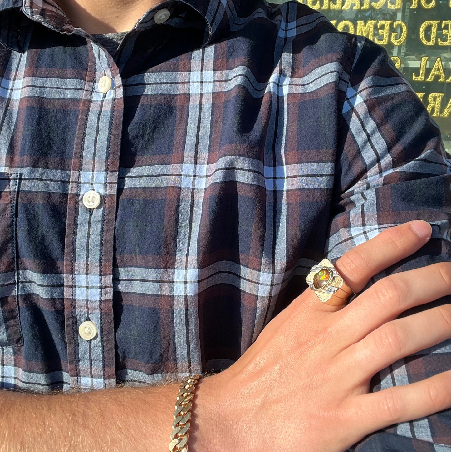 A yellow gold men's ring channel set with diamonds and bezel set with a Mexican fire agate stone.