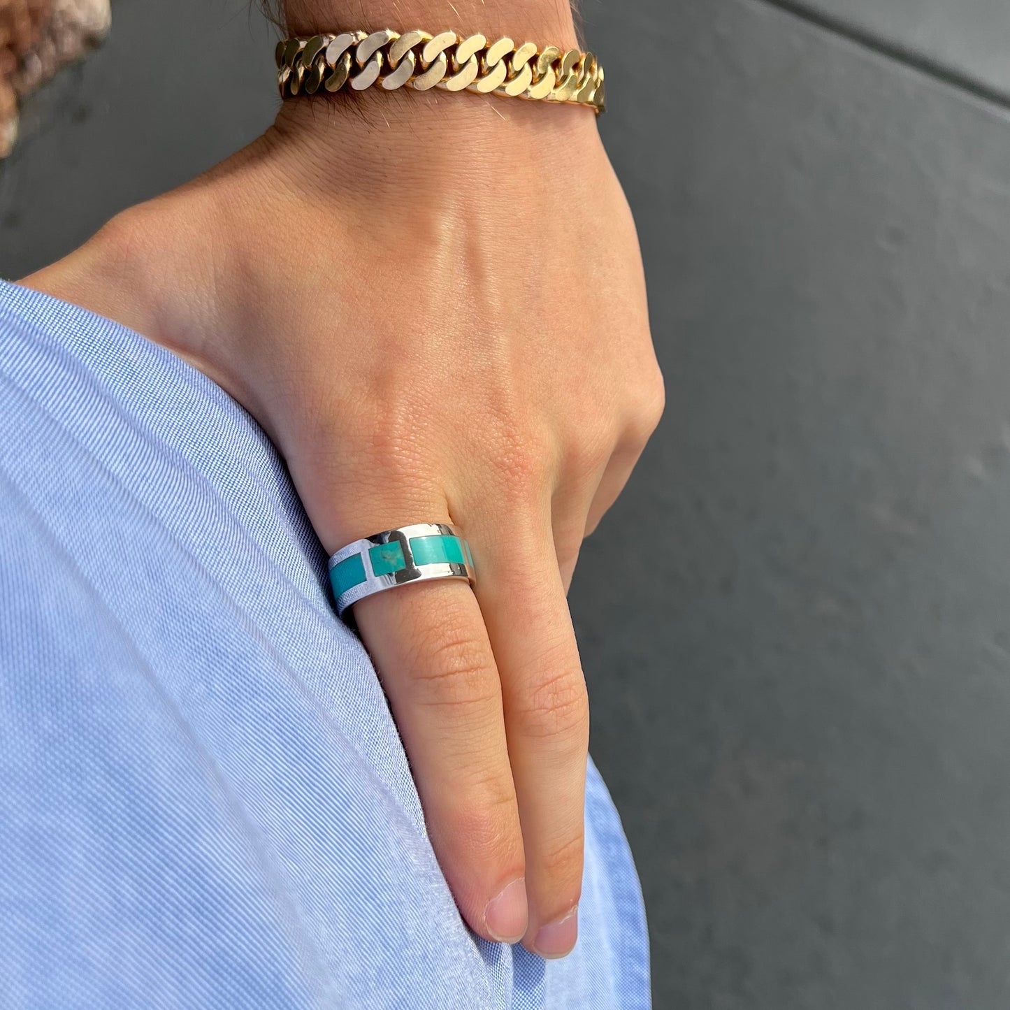 A men's sterling silver wedding band inlaid with natural Sleeping Beauty Turquoise stones that go all the way around.