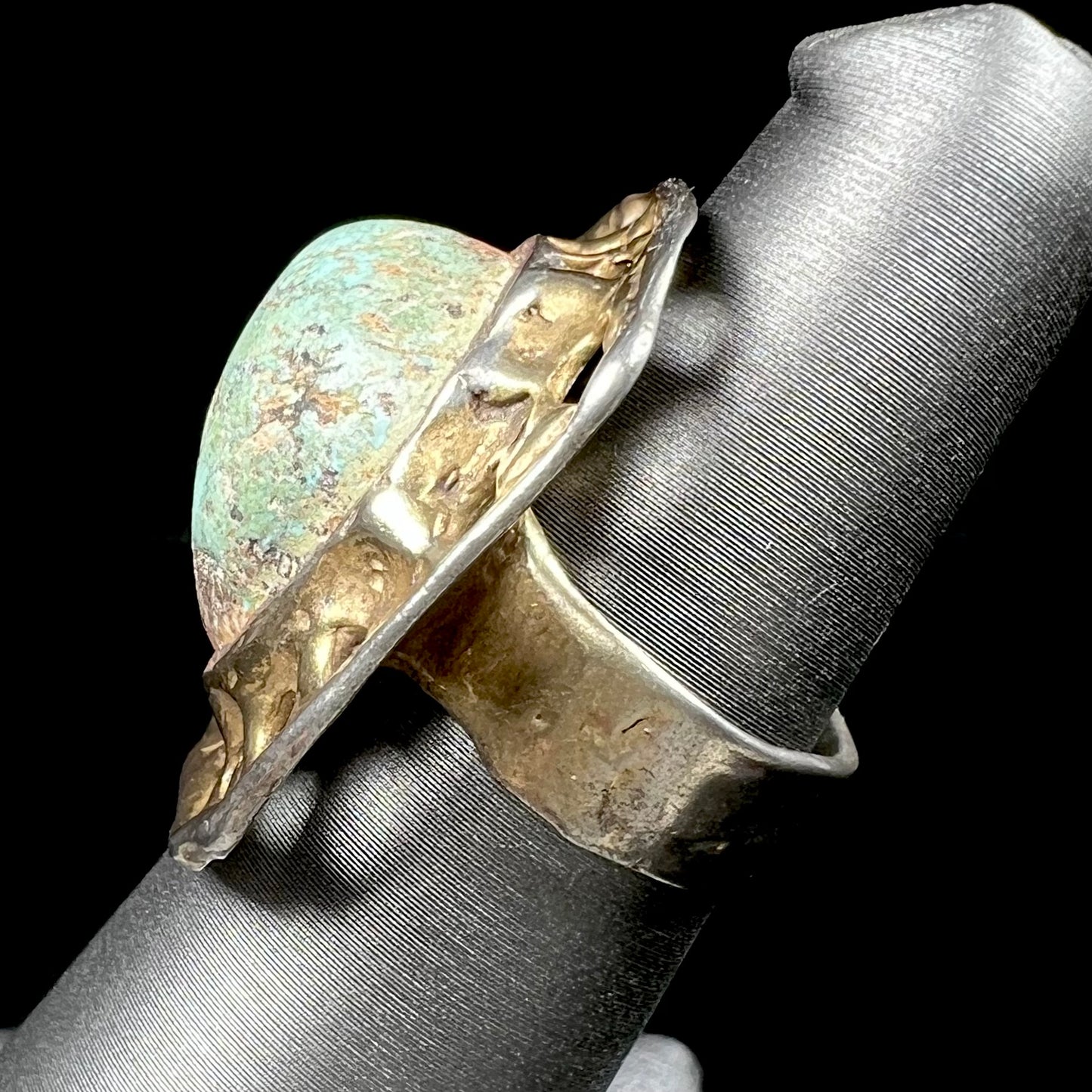 A unisex sterling silver ring with a gold wash, set with a natural, unstabilized Valley Blue turquoise stone.