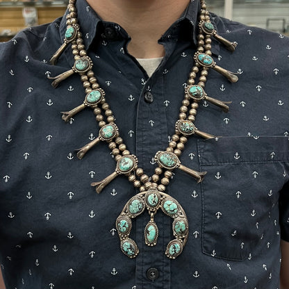 A Native American squash blossom necklace set with Number 8 MIne turquoise stones.