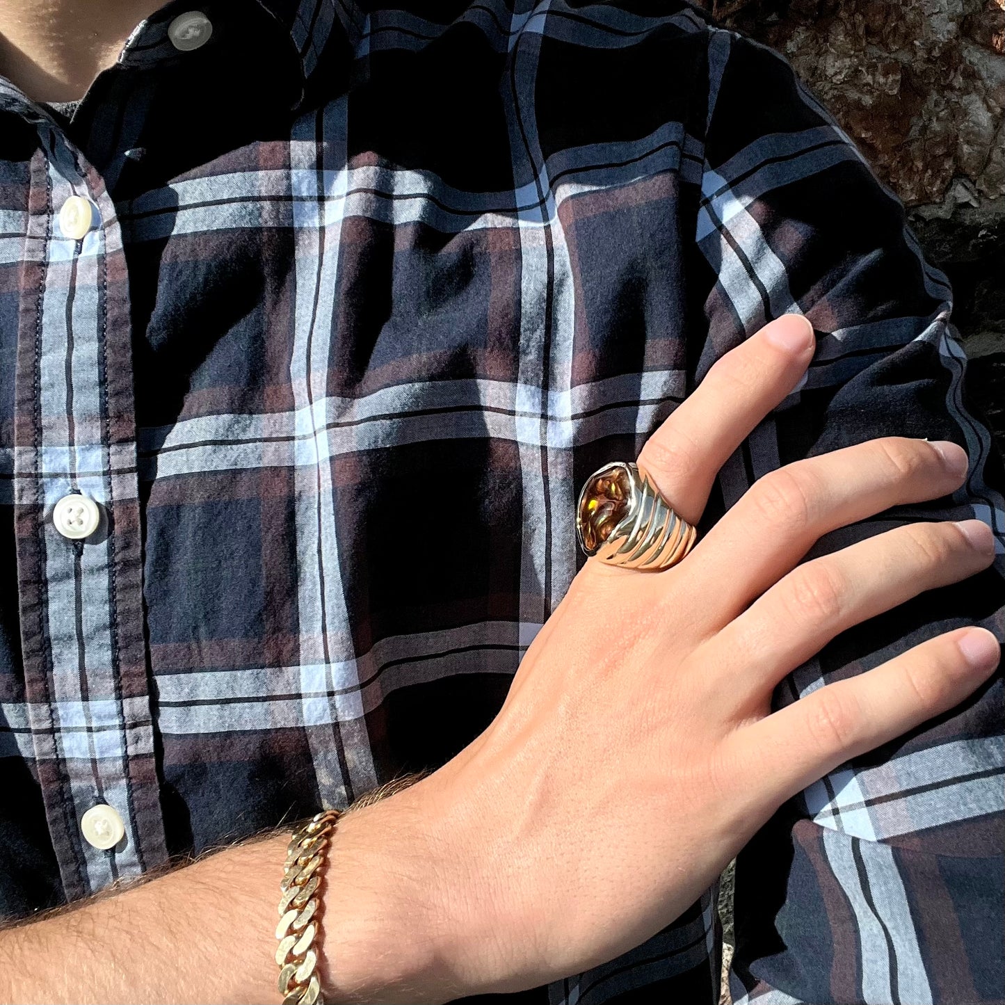 A men's heavy yellow gold ring set with a Mexican fire agate stone and three round brilliant cut diamond accents.