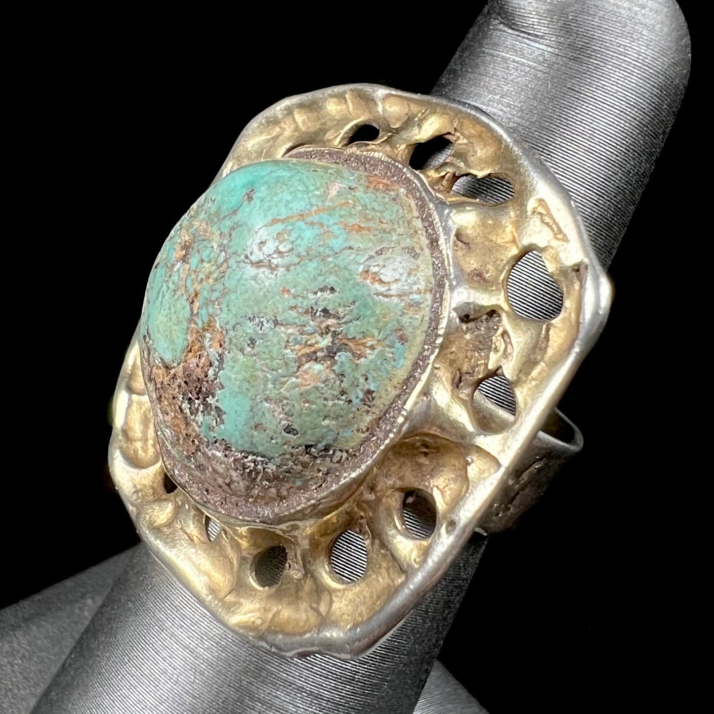 A unisex sterling silver ring with a gold wash, set with a natural, unstabilized Valley Blue turquoise stone.