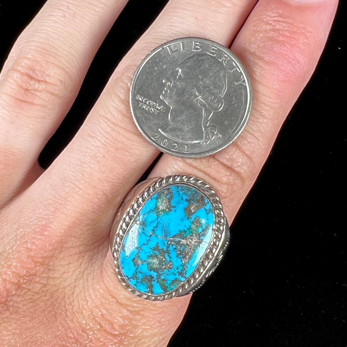 A men's sterling silver Morenci turquoise solitaire ring. The ring has a Southwest Navajo style stamp pattern.