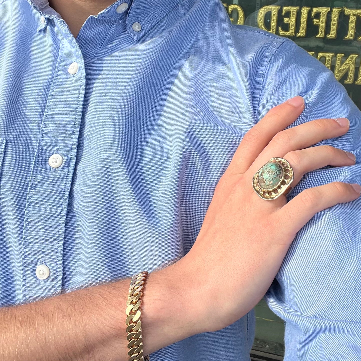 A unisex sterling silver ring with a gold wash, set with a natural, unstabilized Valley Blue turquoise stone.