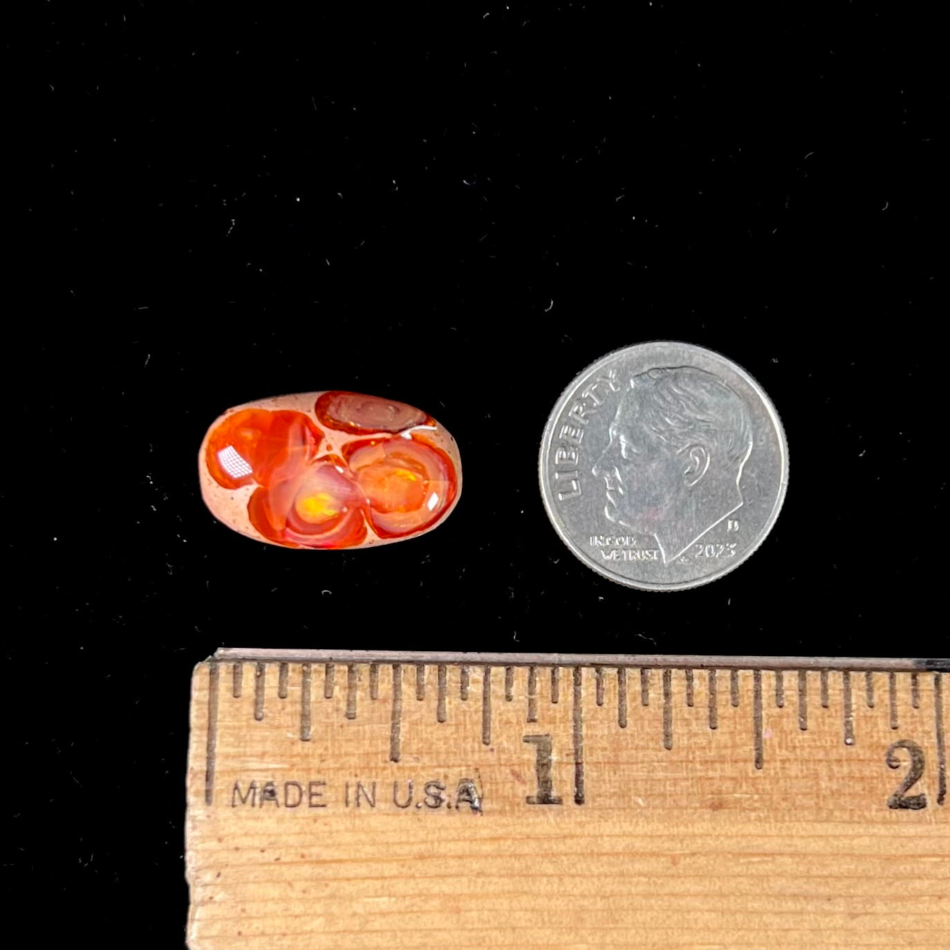 A loose Mexican matrix fire opal stone. The opal is orange with green flashes.