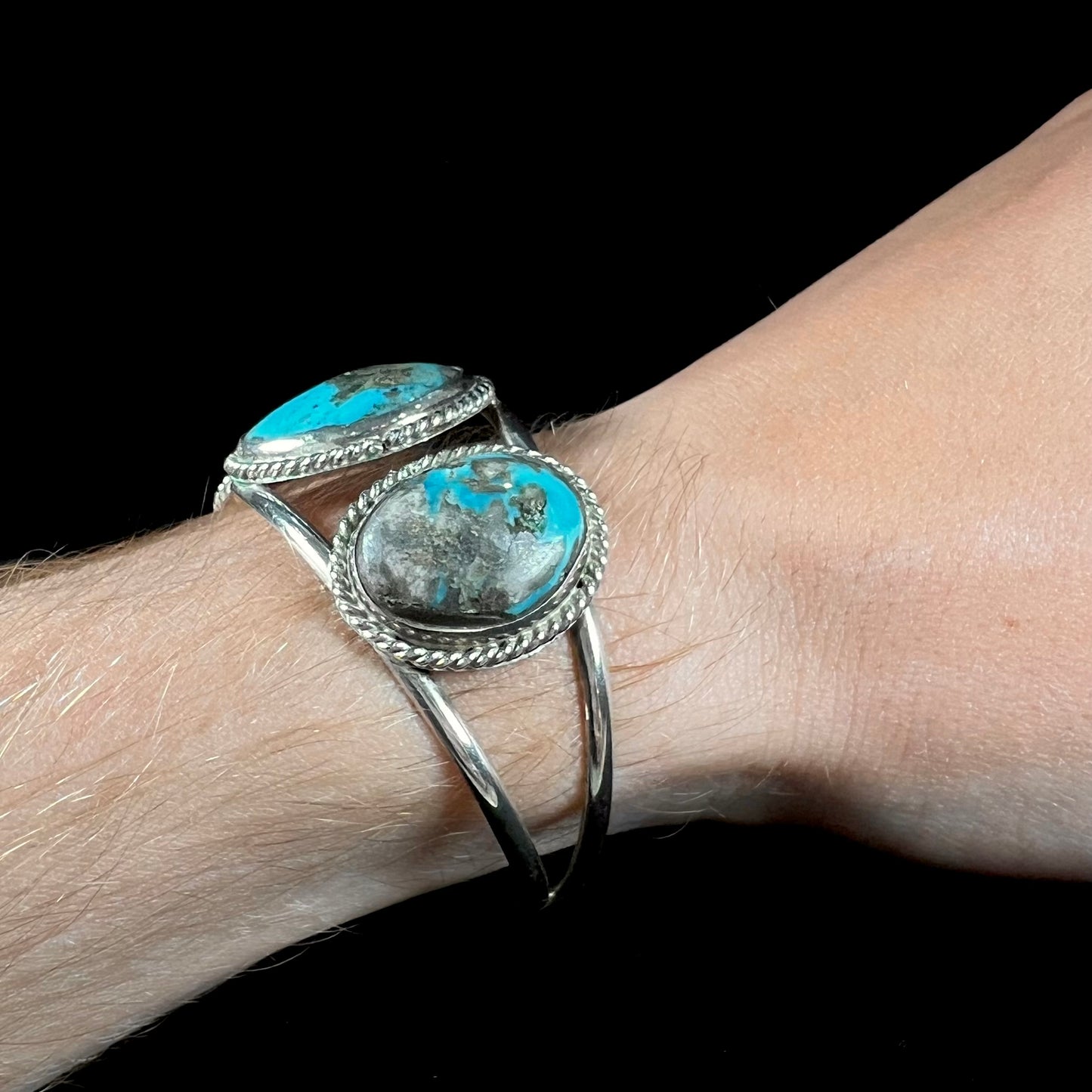 A ladies' three stone silver cuff bracelet accented with rope bezels and set with Morenci turquoise.
