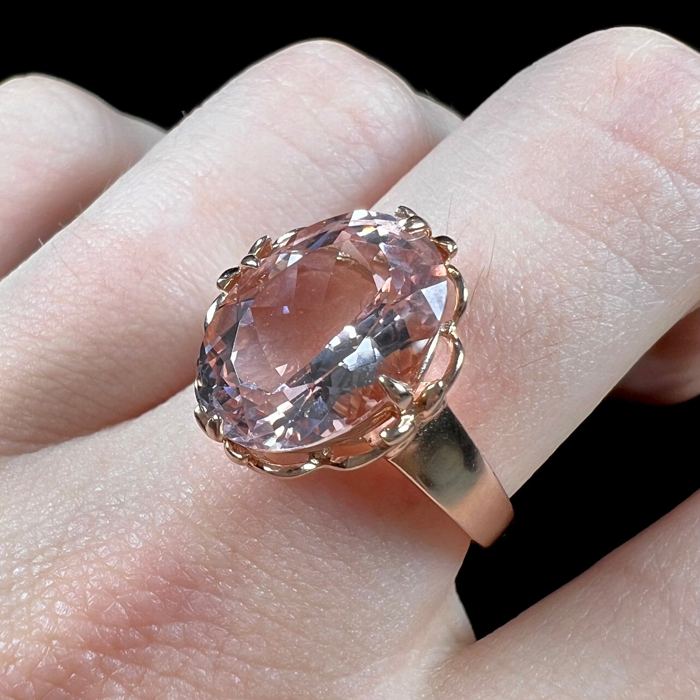 A ladies' rose gold solitaire ring set with an oval cut pink morganite gemstone.