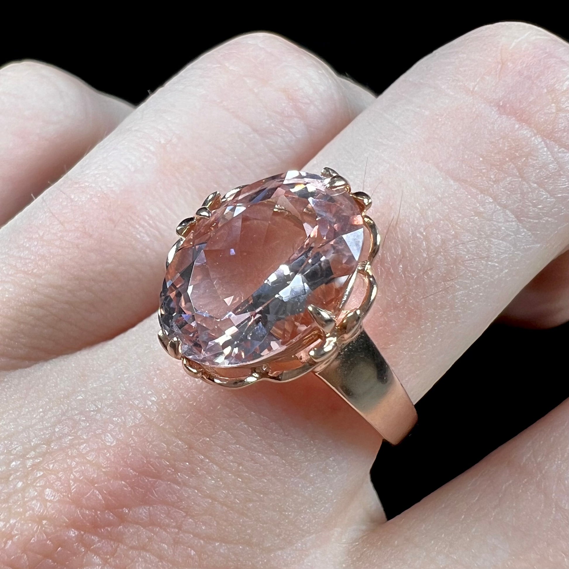 A ladies' rose gold solitaire ring set with an oval cut pink morganite gemstone.