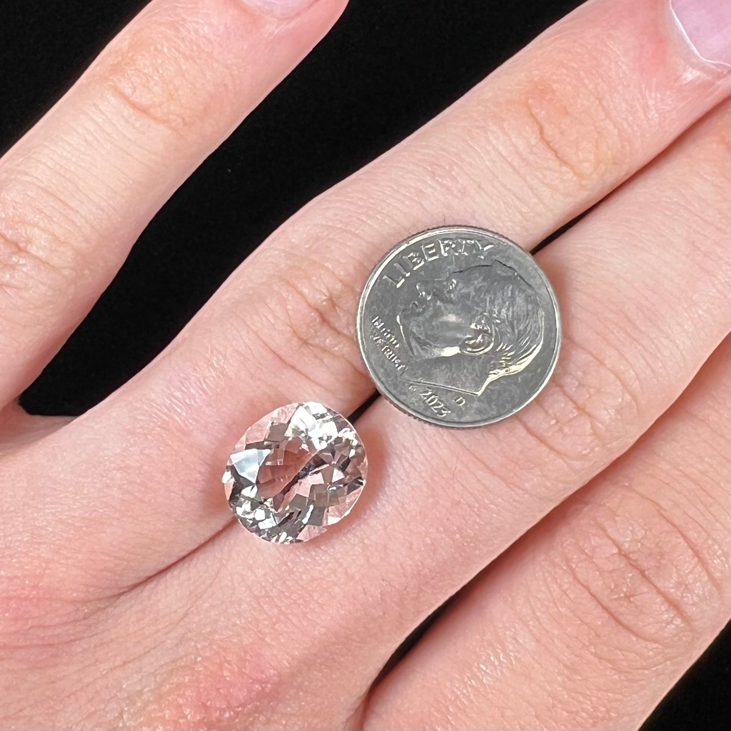A loose, faceted oval cut pink morganite gemstone.