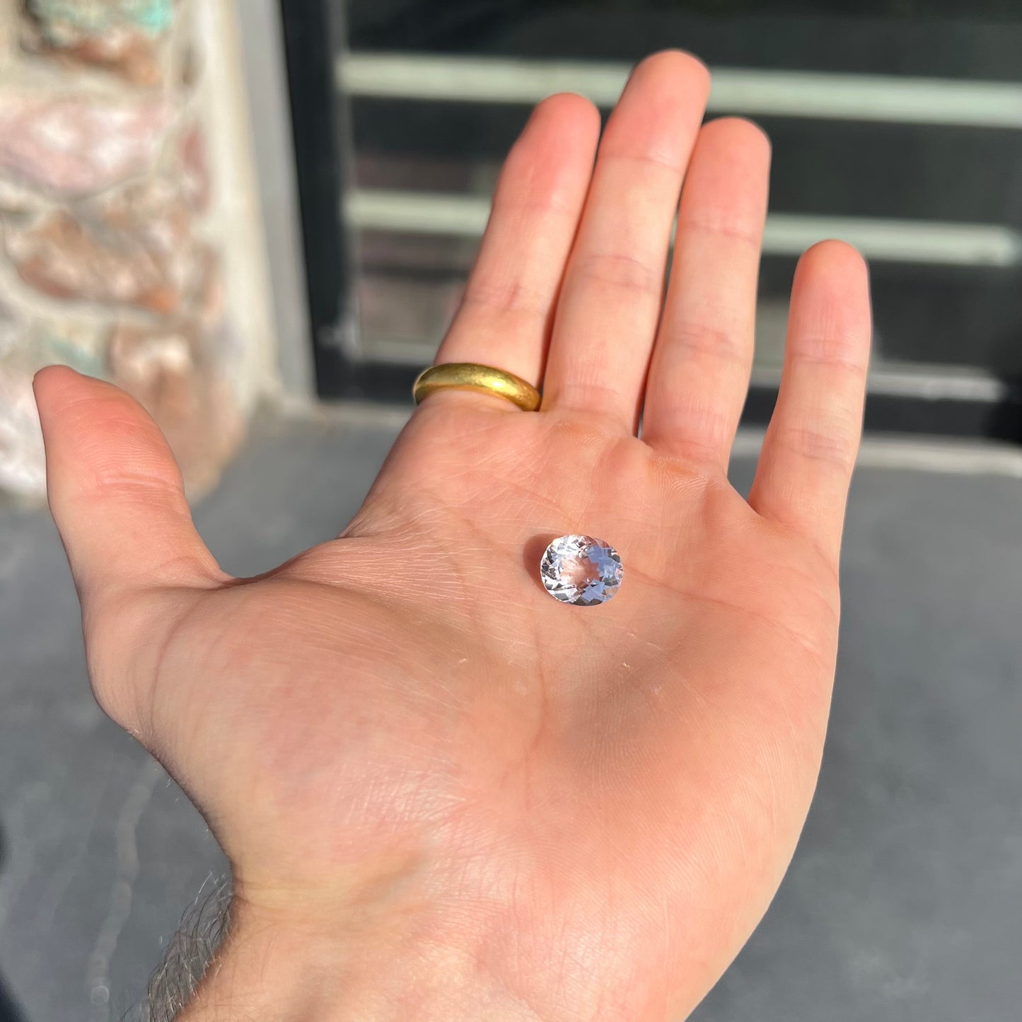 A loose, faceted oval cut pink morganite gemstone.