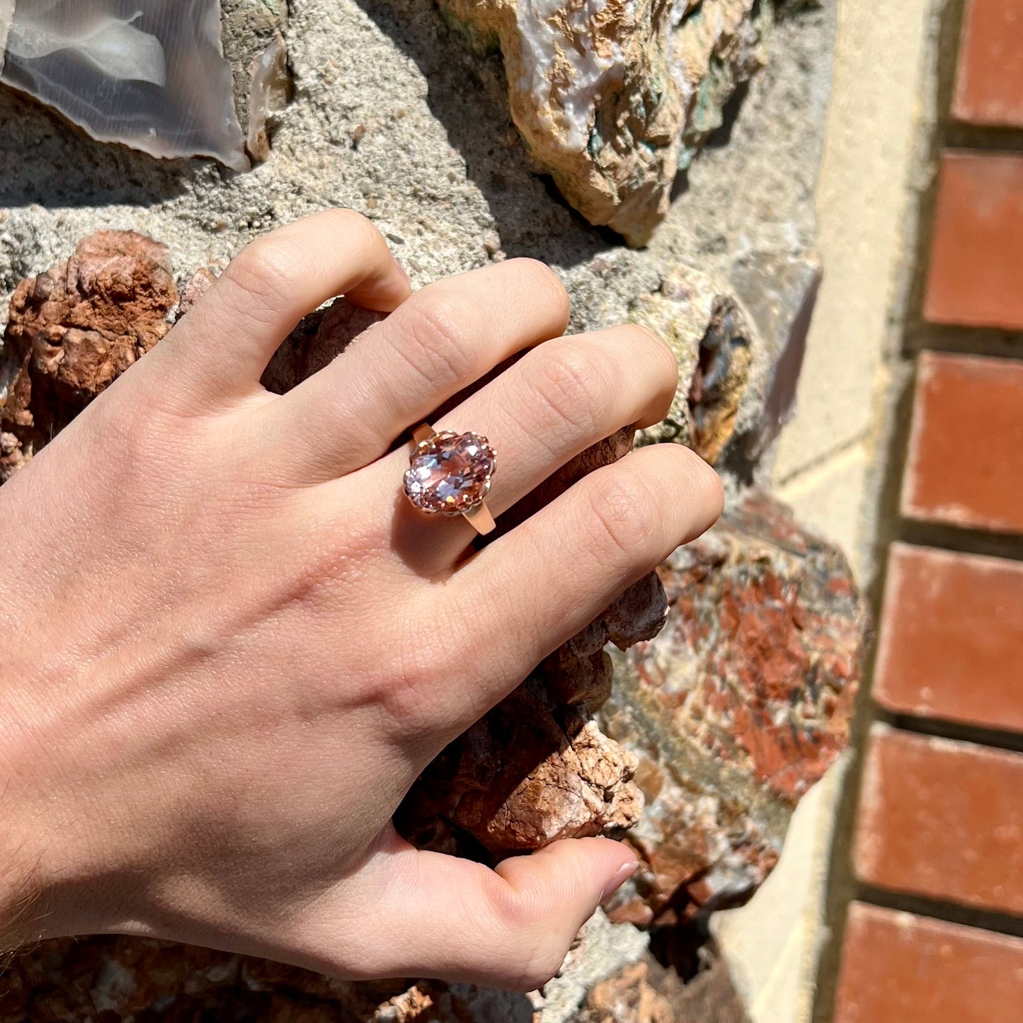 A ladies' rose gold solitaire ring set with an oval cut pink morganite gemstone.