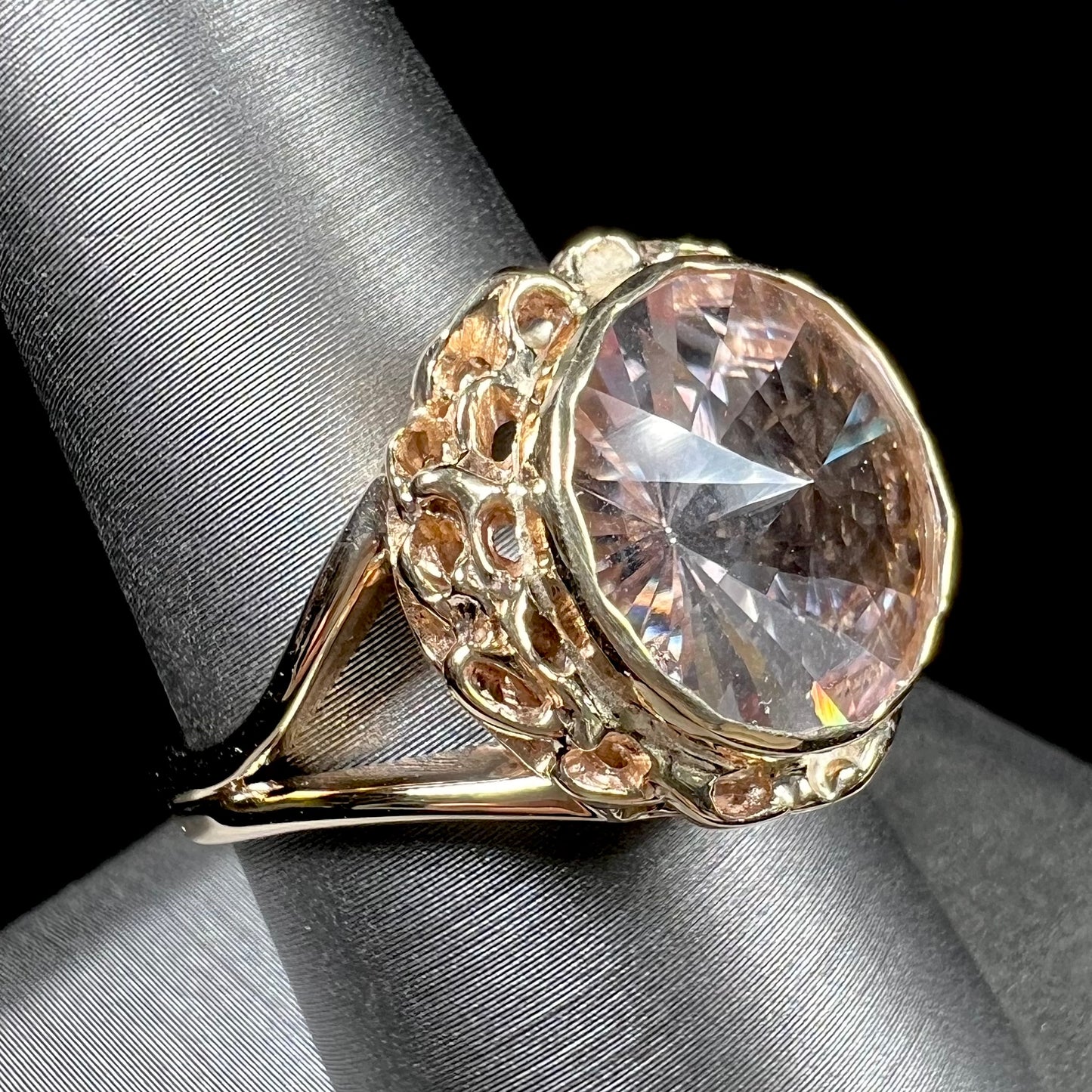 A ladies' yellow gold solitaire ring bezel set with a modified bud cut morganite gemstone.