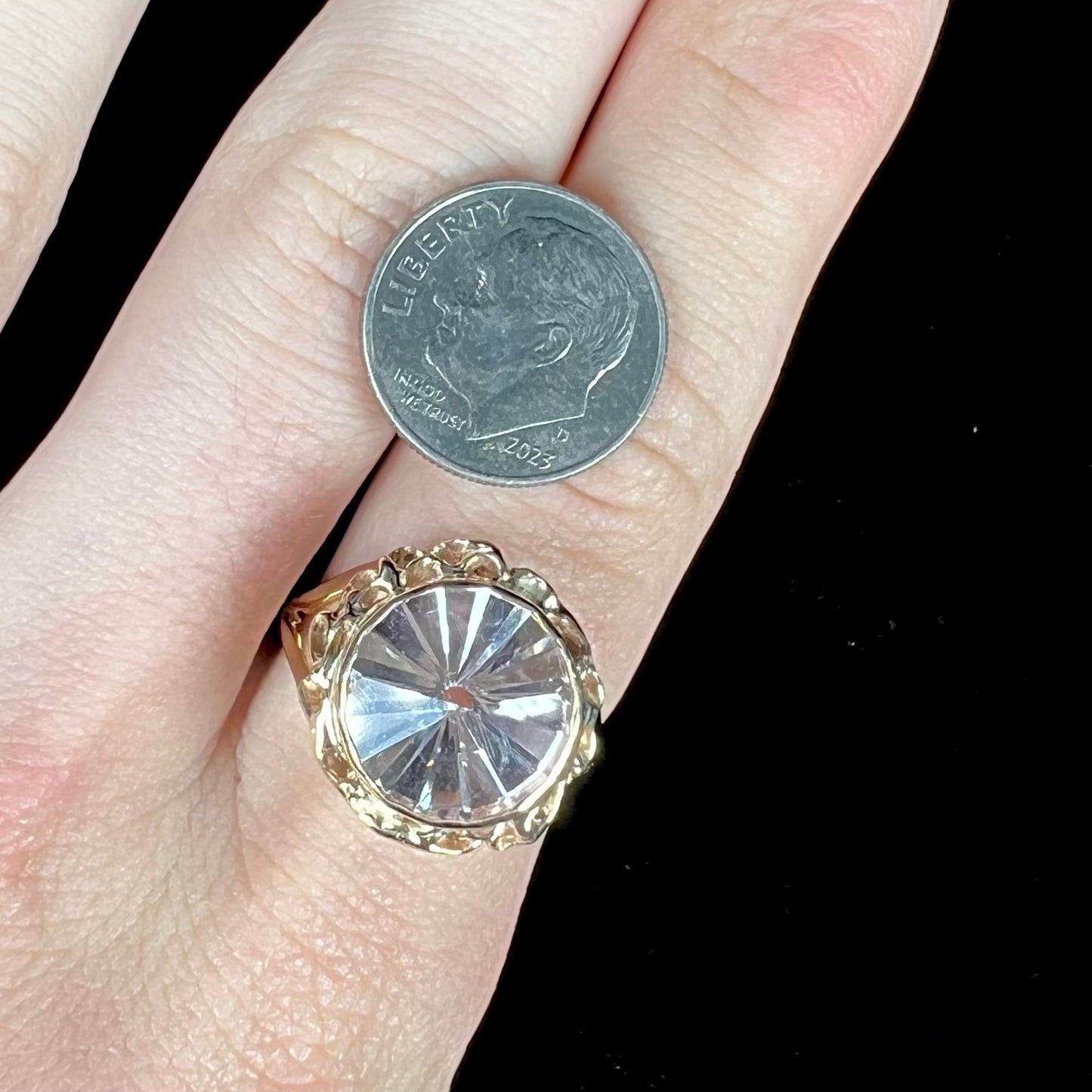 A ladies' yellow gold solitaire ring bezel set with a modified bud cut morganite gemstone.