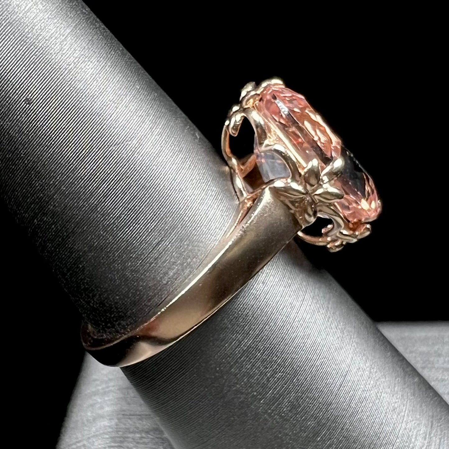 A ladies' rose gold solitaire ring set with an oval cut pink morganite gemstone.