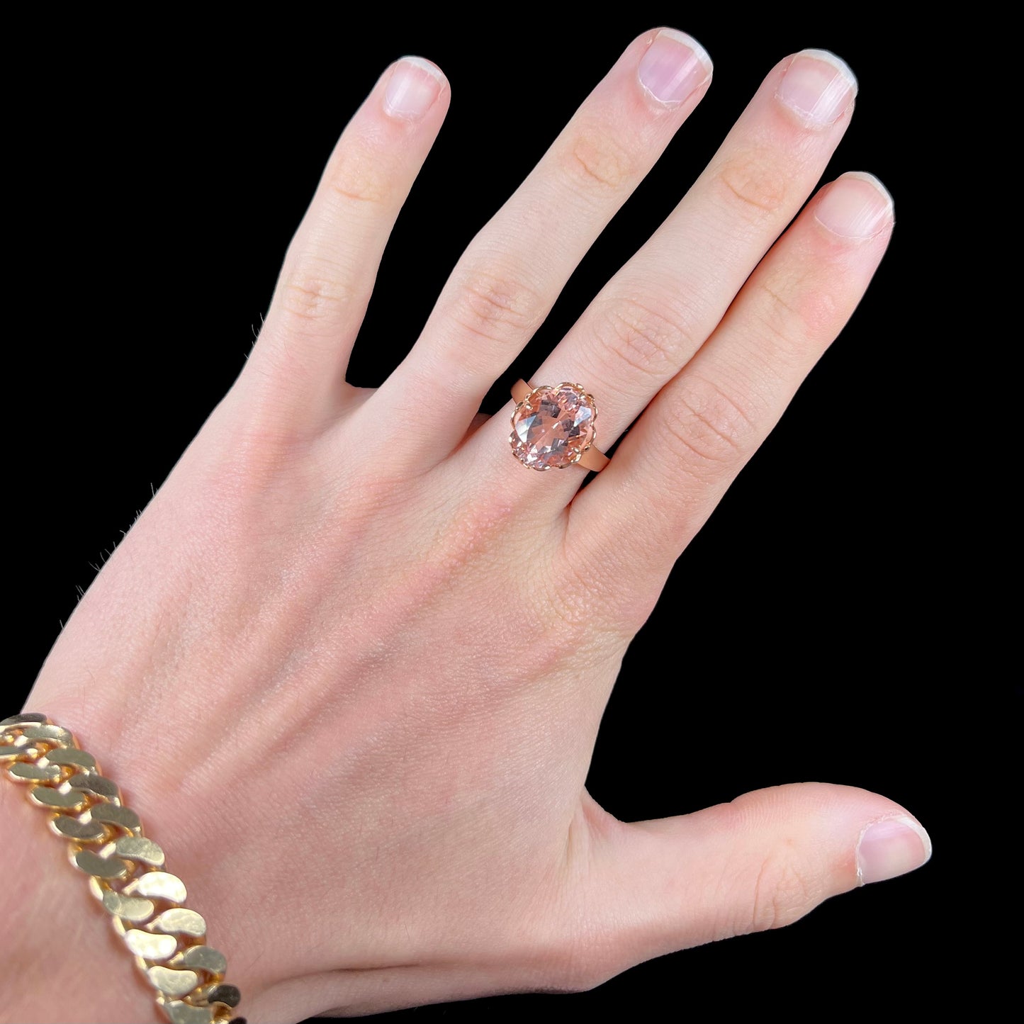 A ladies' rose gold solitaire ring set with an oval cut pink morganite gemstone.