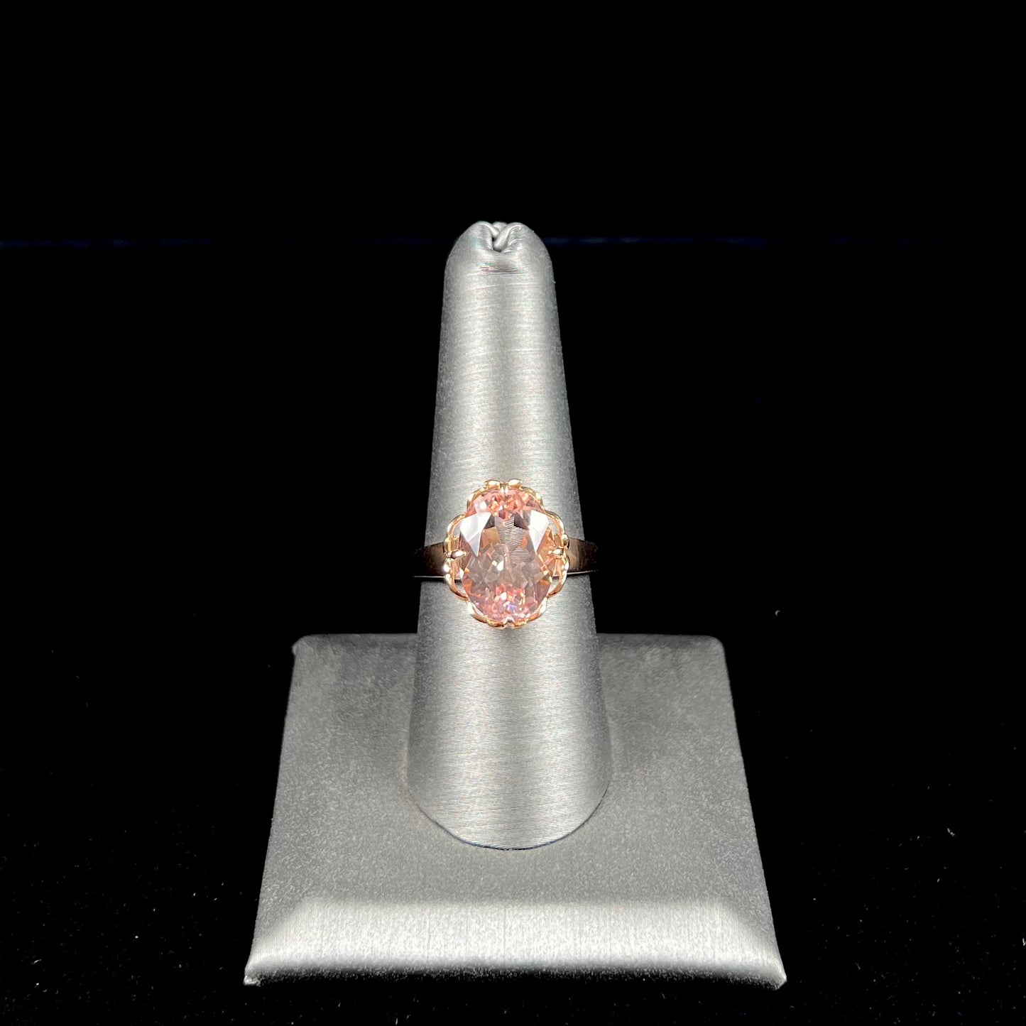 A ladies' rose gold solitaire ring set with an oval cut pink morganite gemstone.