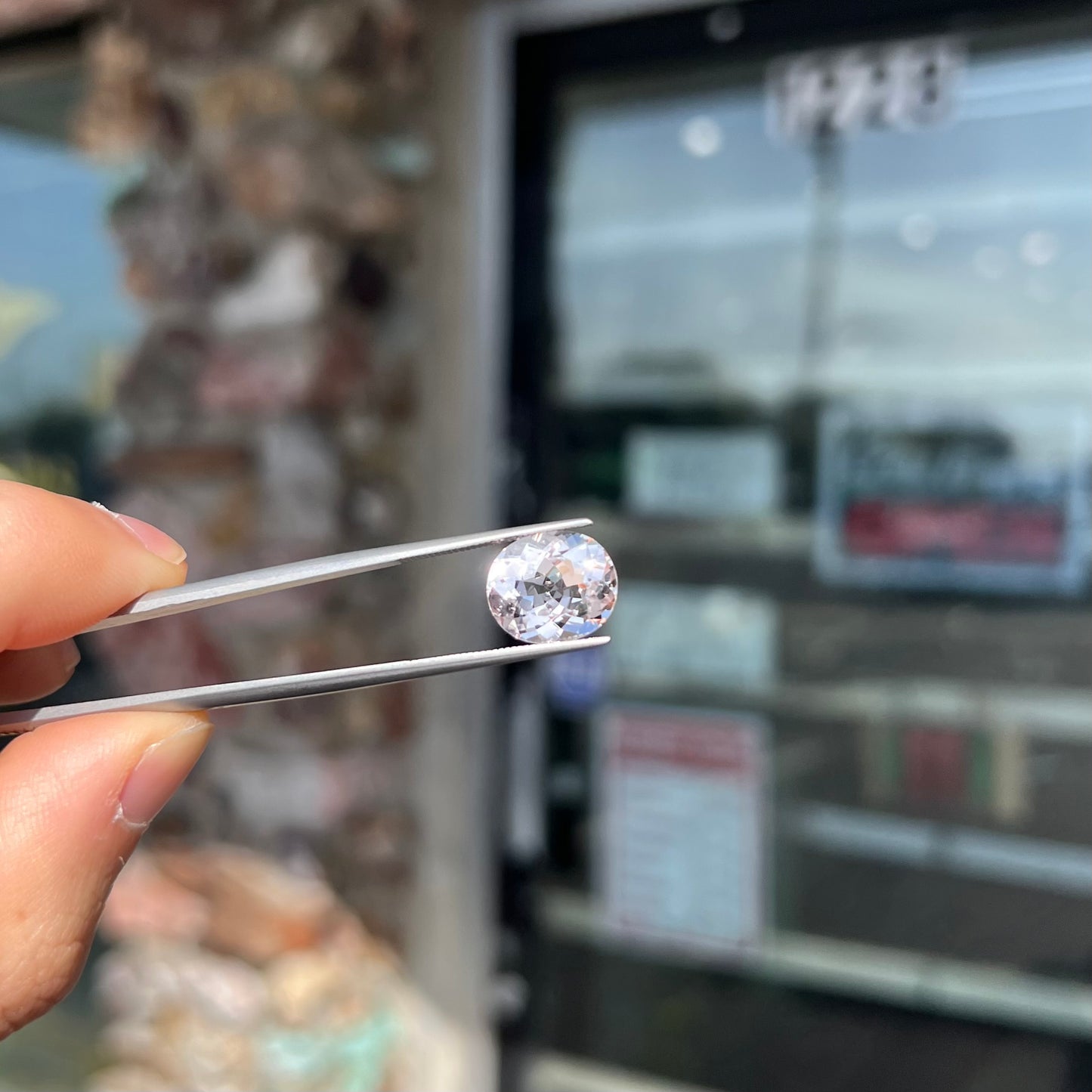A loose, faceted oval cut pink morganite gemstone.