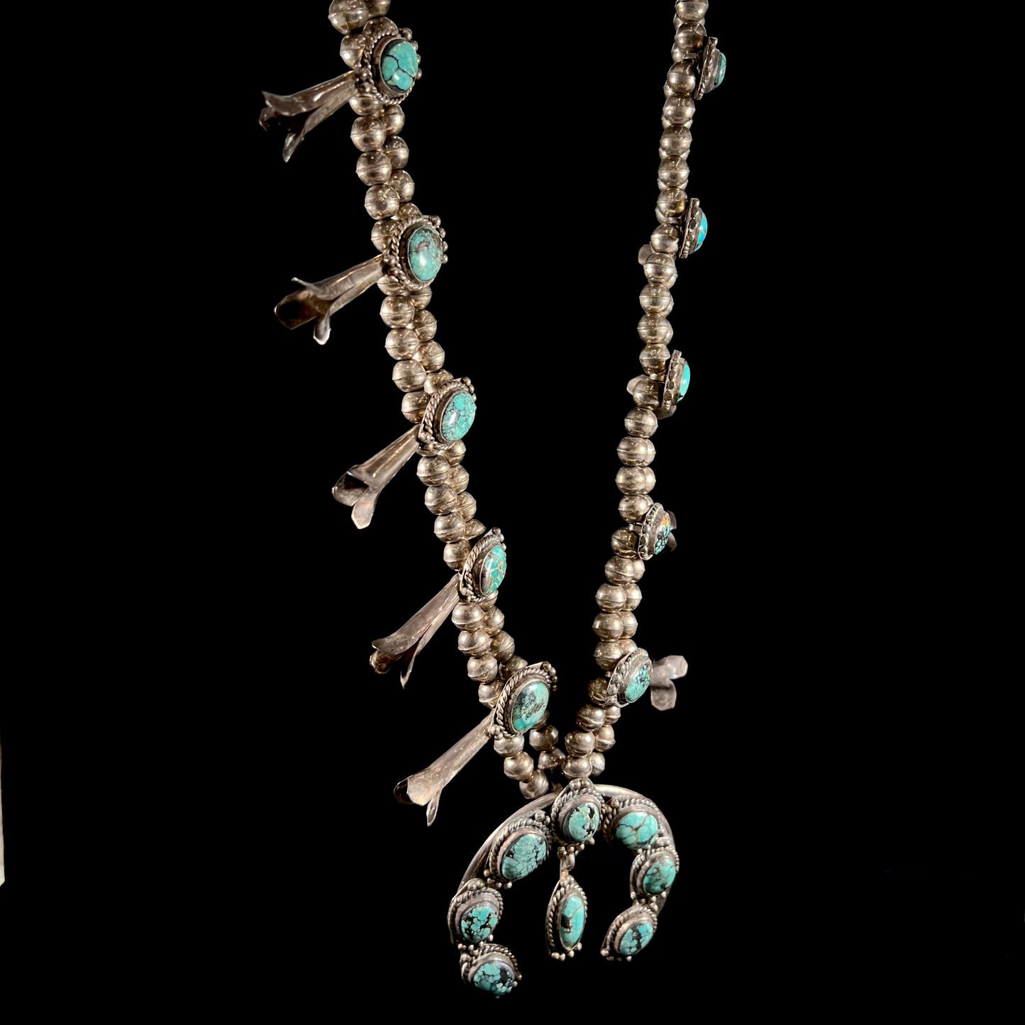 A Native American squash blossom necklace set with Number 8 MIne turquoise stones.