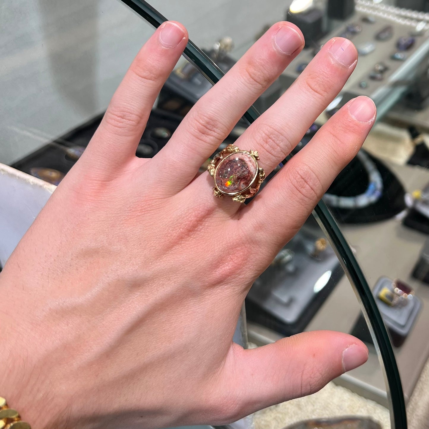 A ladies' estate yellow gold solitaire ring set with an oval cabochon cut natural Cantera fire opal.