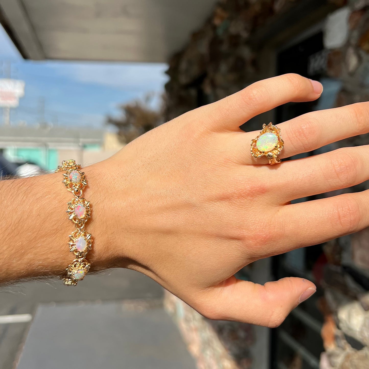 A ladies' yellow gold bracelet set with natural, oval cabochon cut white crystal opals.