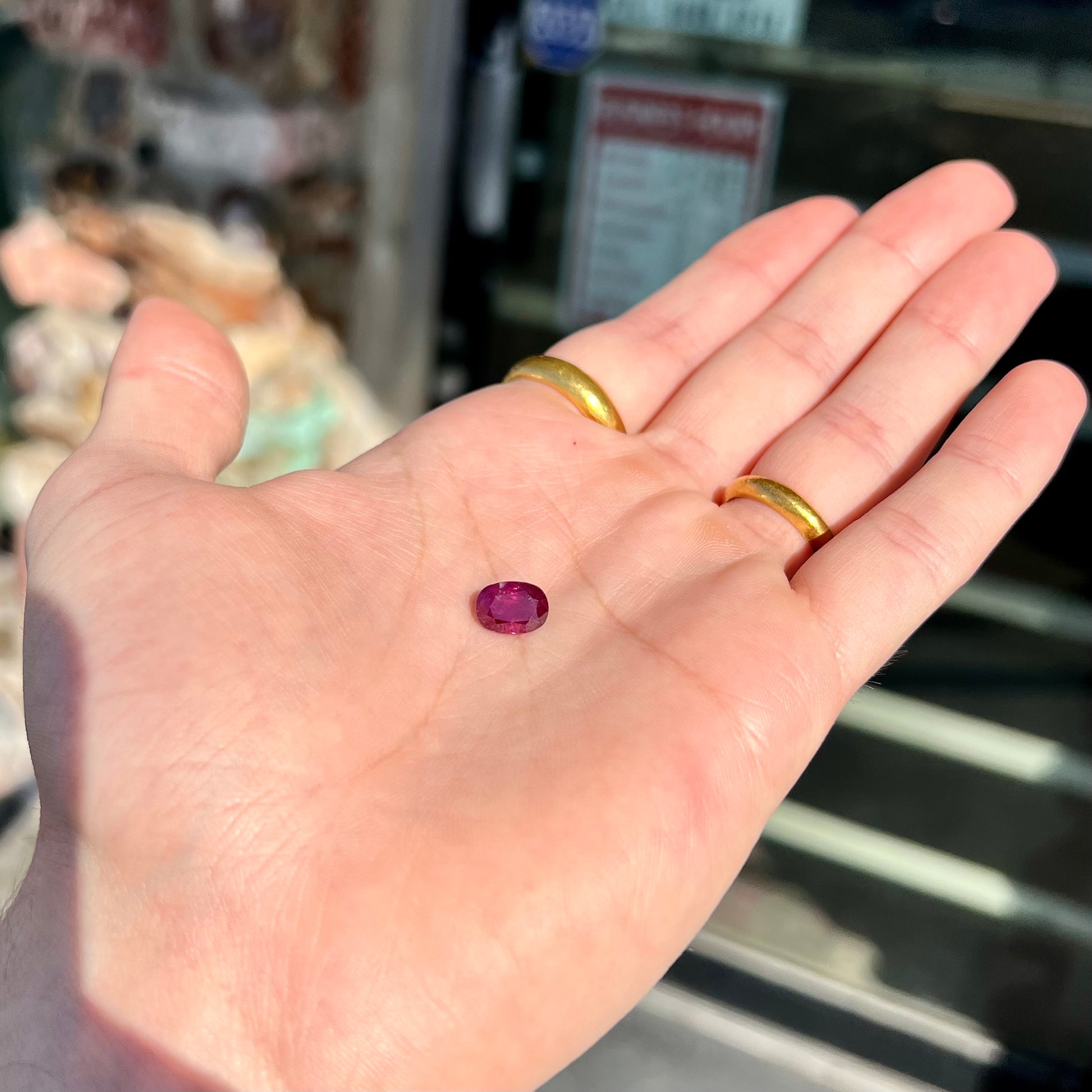 A loose, natural purplish ruby gemstone.  There is a small, minute chip on the girdle of the gem.