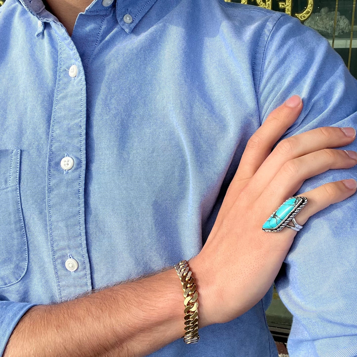 A vintage, Southwest style sterling silver ring set with a natural turquoise stone. The stone is blue with a black matrix.