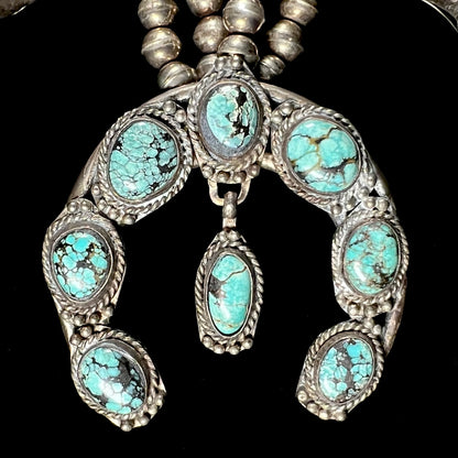 A Native American squash blossom necklace set with Number 8 MIne turquoise stones.
