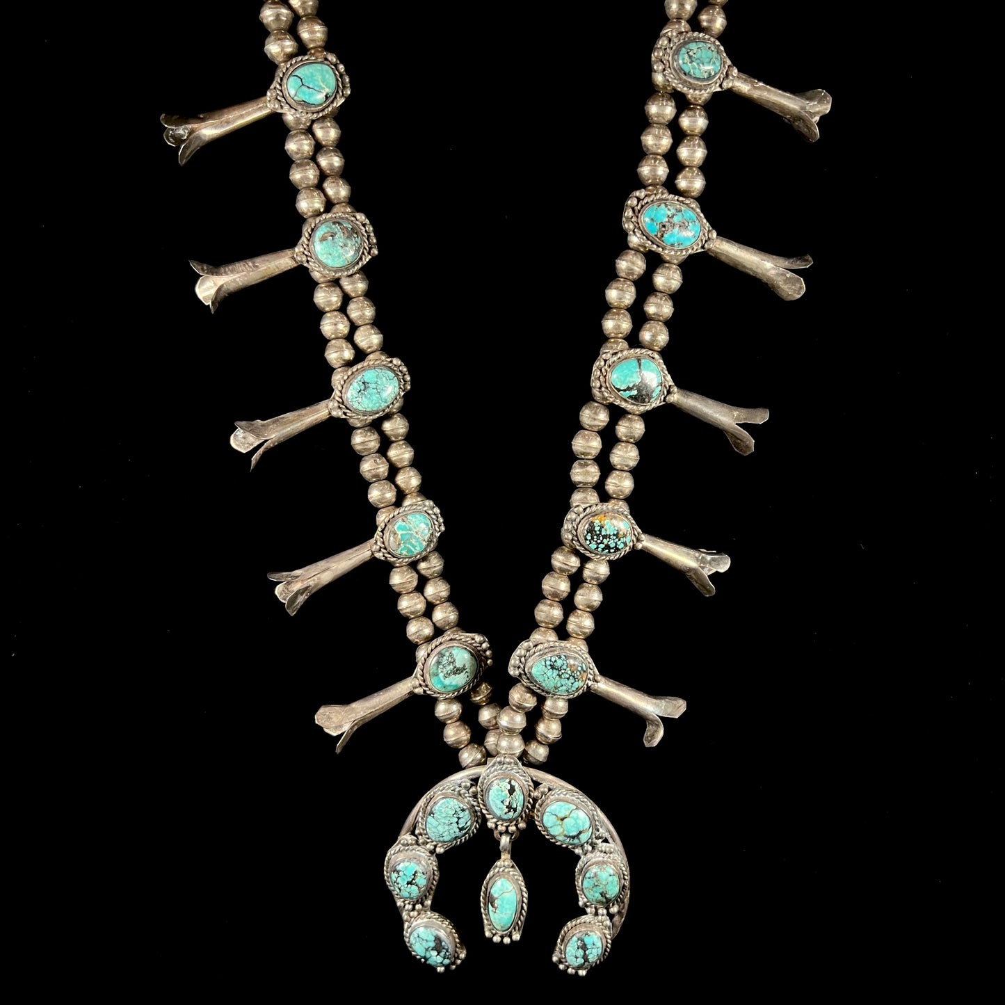 A Native American squash blossom necklace set with Number 8 MIne turquoise stones.