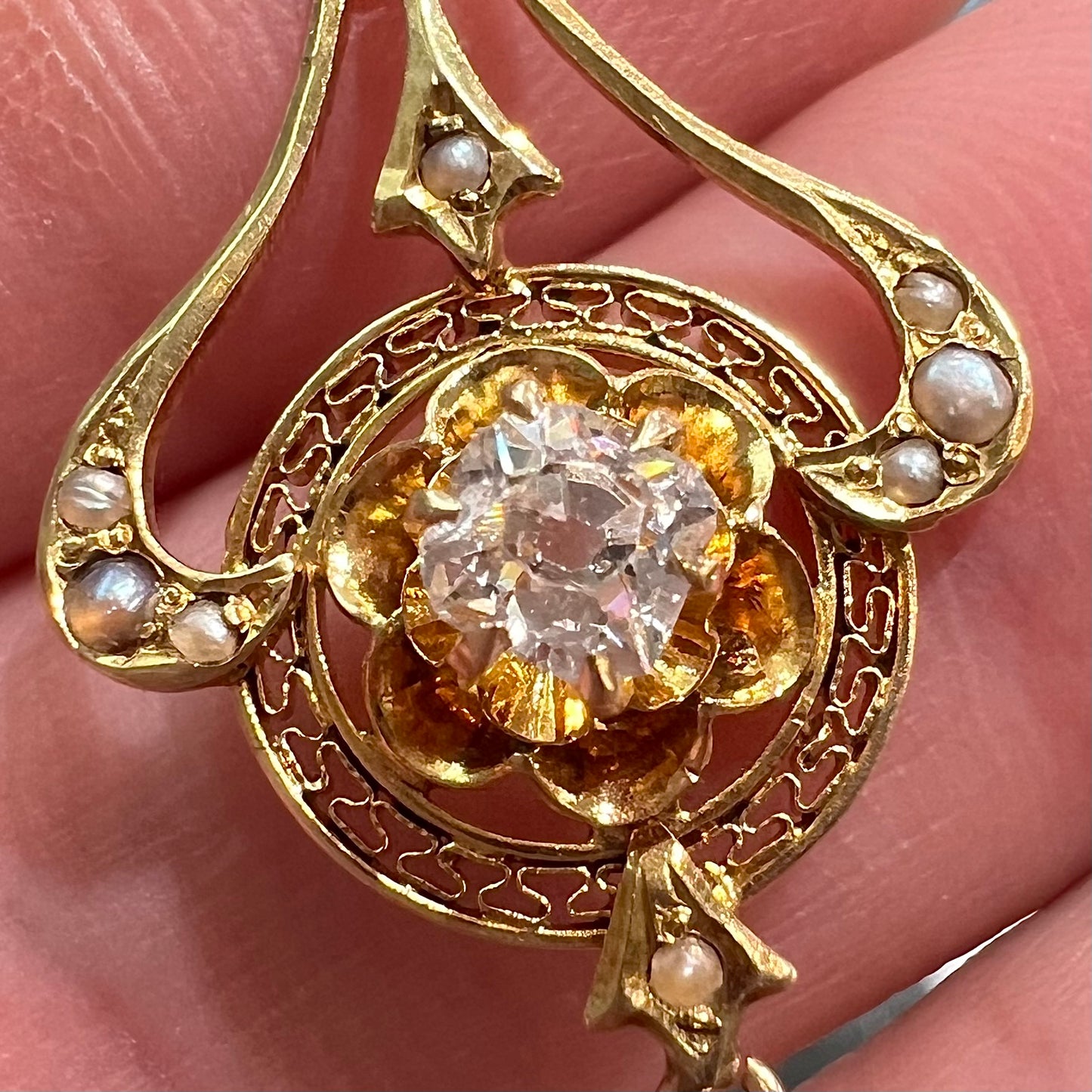 A ladies' Edwardian style gold necklace set with pearls and an old mine cut diamond. The chain is marked "1916".