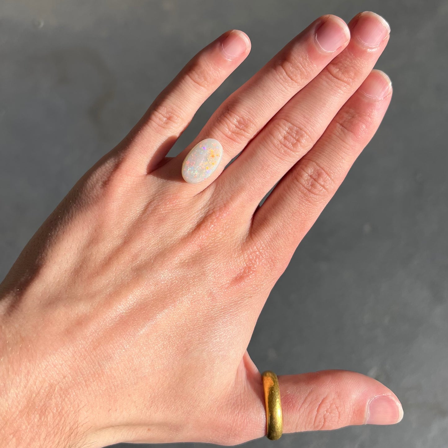 An oval cabochon cut opal from Coober Pedy, Australia. The opal has predominantly red fire.