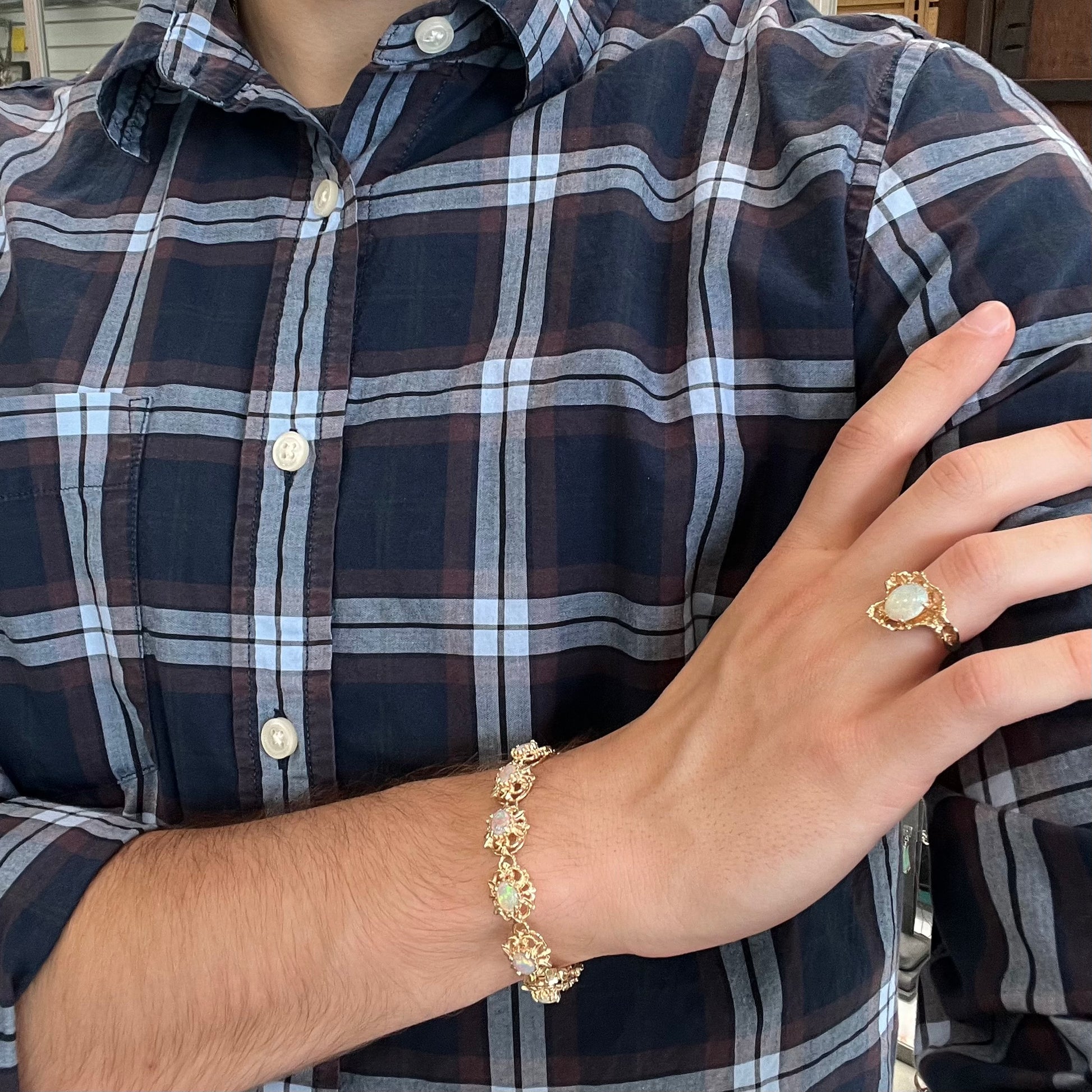 A ladies' yellow gold bracelet set with natural, oval cabochon cut white crystal opals.