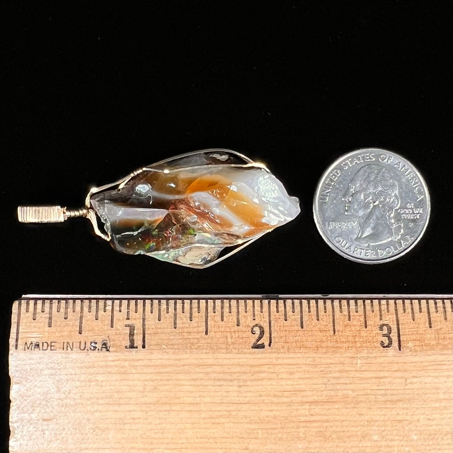 A gold filled wire wrapped pendant set with a natural Virgin Valley, Nevada opal crystal.