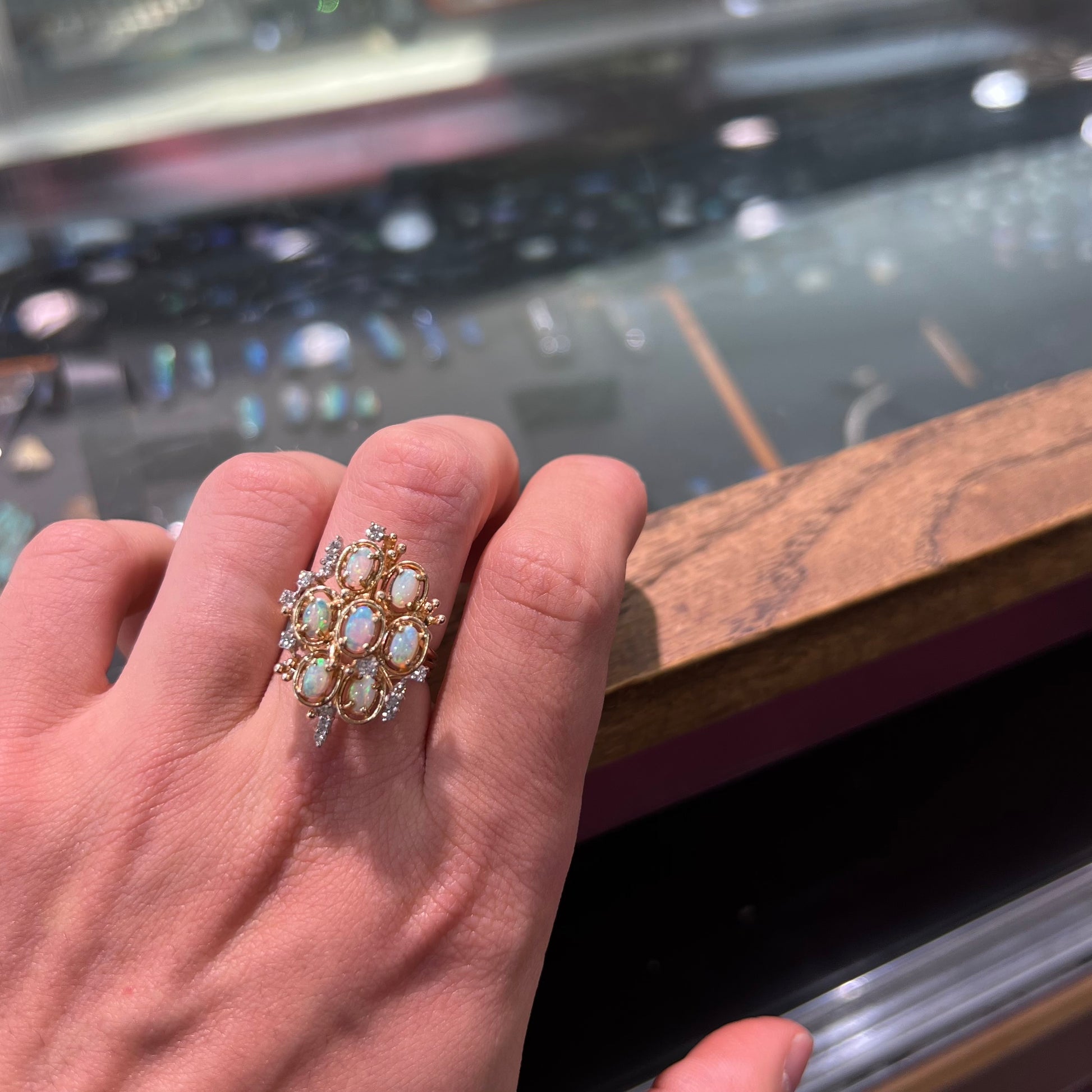 A ladies' vintage mid-century modern style opal and diamond cluster ring in yellow gold.