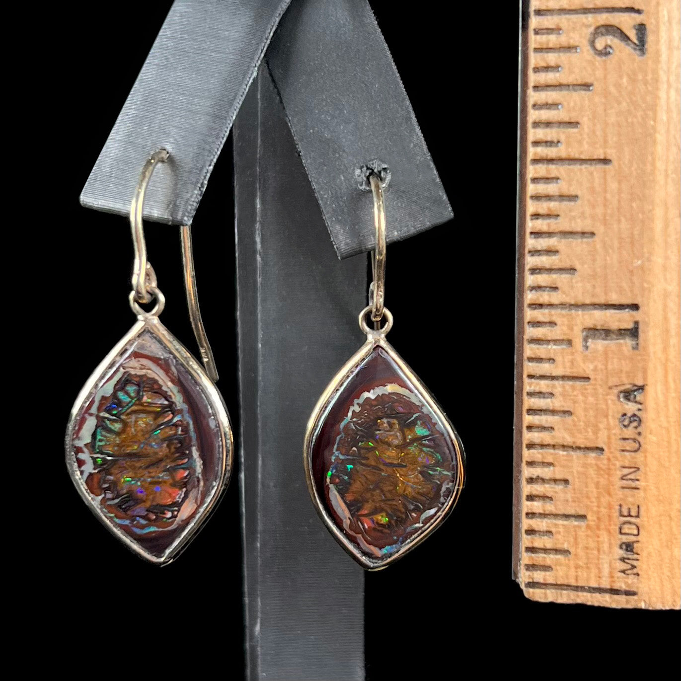 A pair of yellow gold dangle earrings bezel set with natural boulder opals from Koroit, Australia.