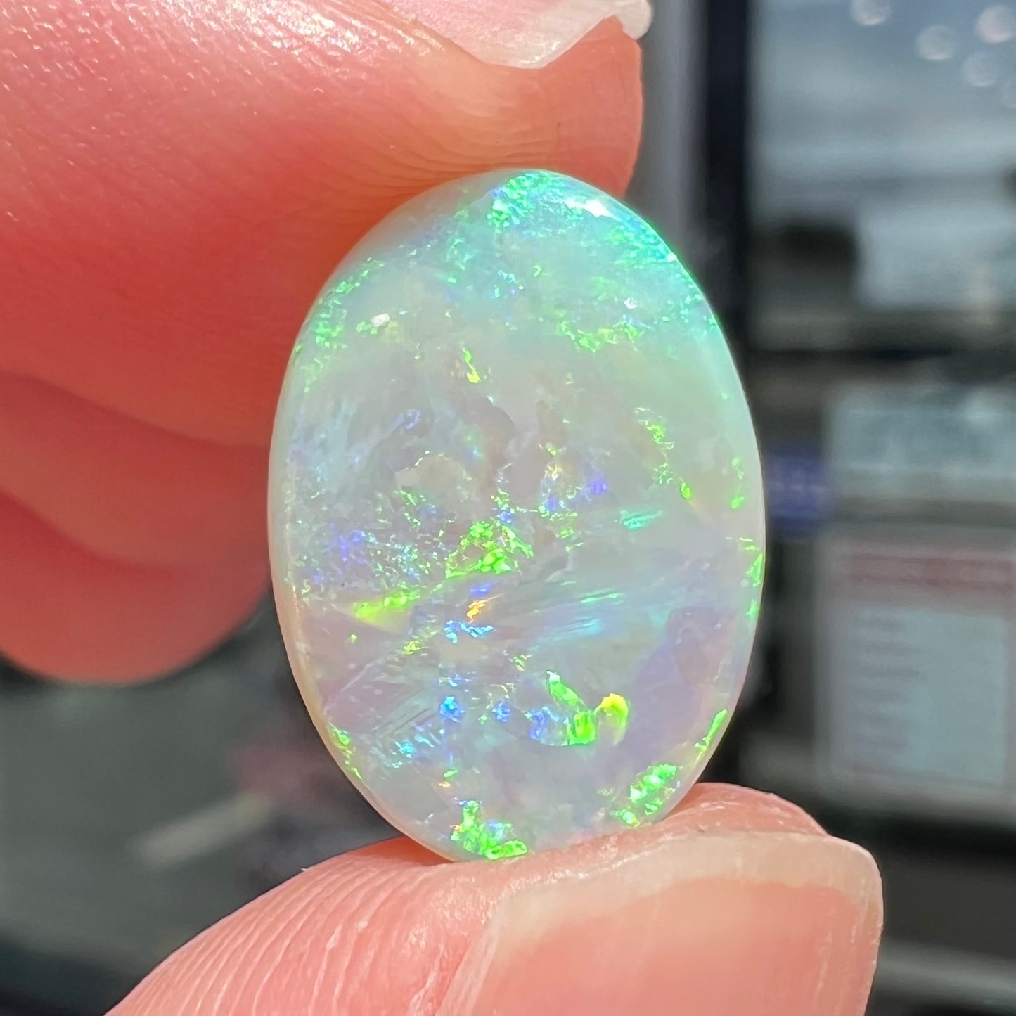 A double-sided opal stone from Coober Pedy, Australia. The opal plays green, blue, and orange colors from the front and the back.