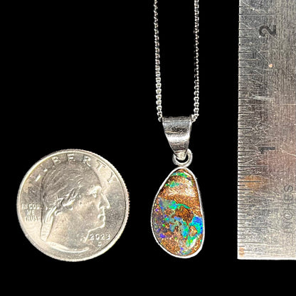 A sterling silver pendant set with an Australian boulder opal on a silver box chain.