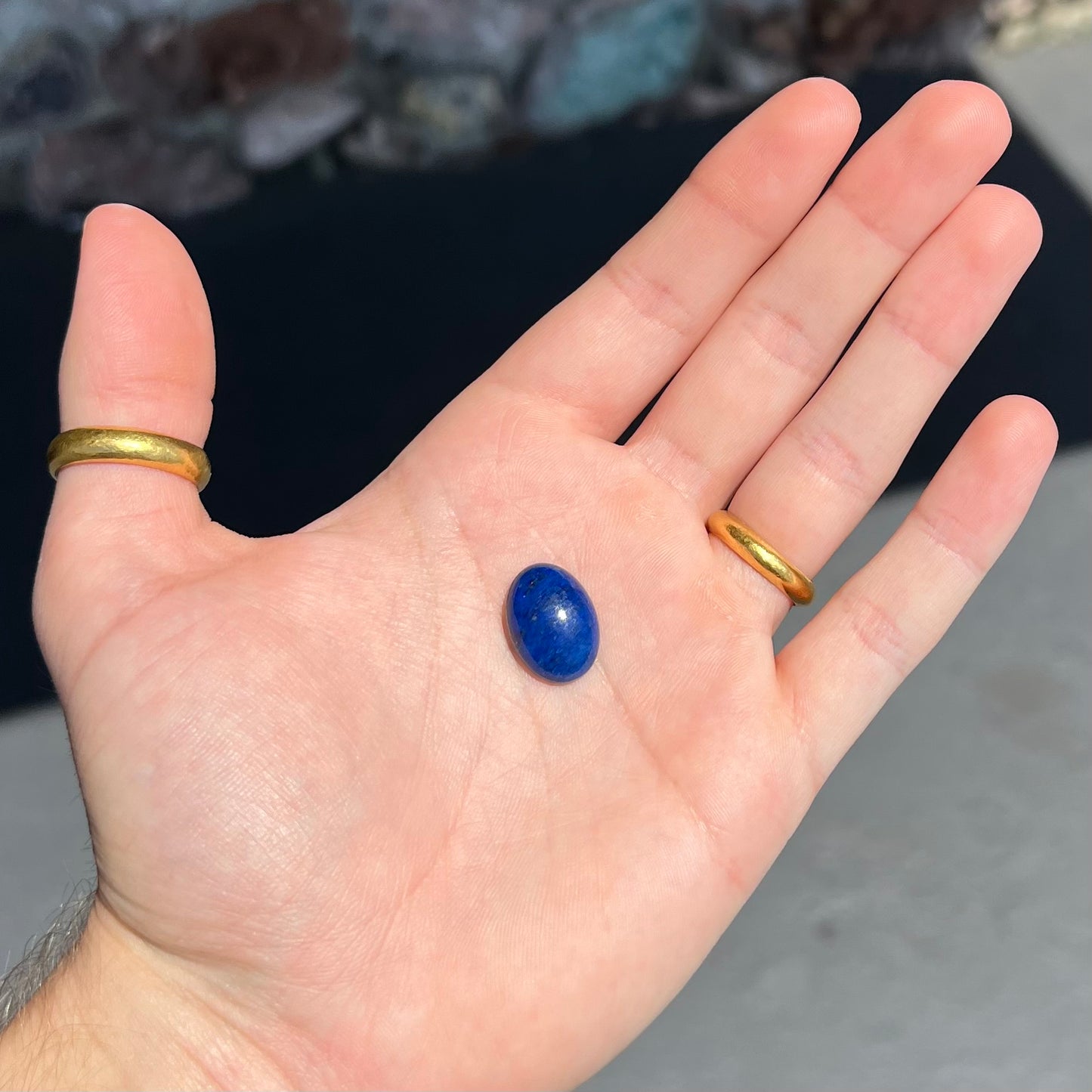 A loose, oval cabochon cut lapis lazuli stone from Blue Mountain, Afghanistan.