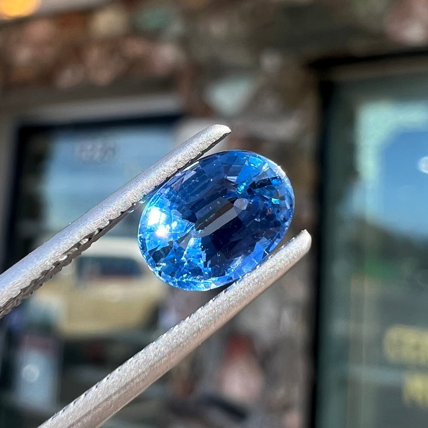 A loose, faceted oval cut blue kyanite gemstone.