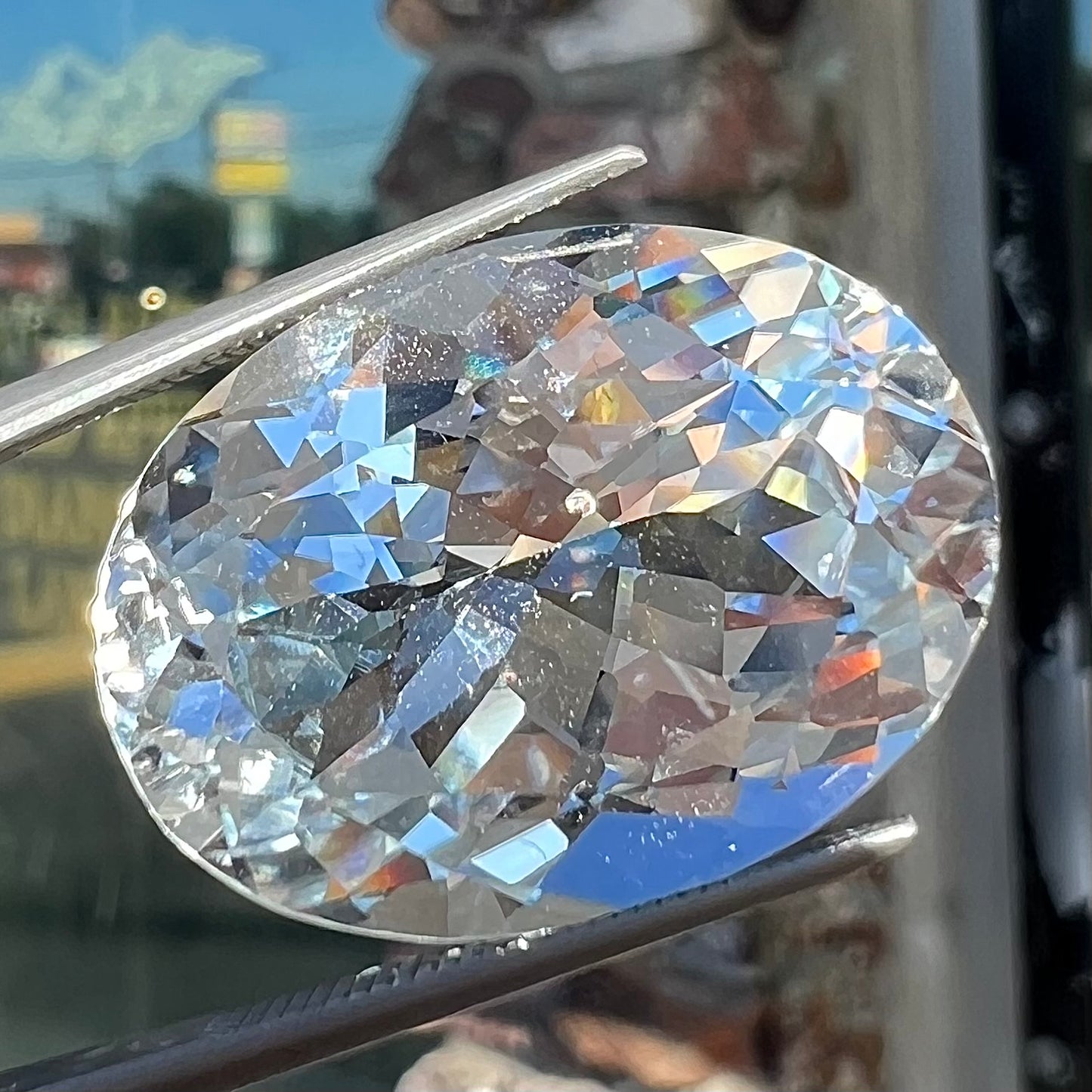 A loose, faceted oval cut white topaz gemstone. The stone is large in size.