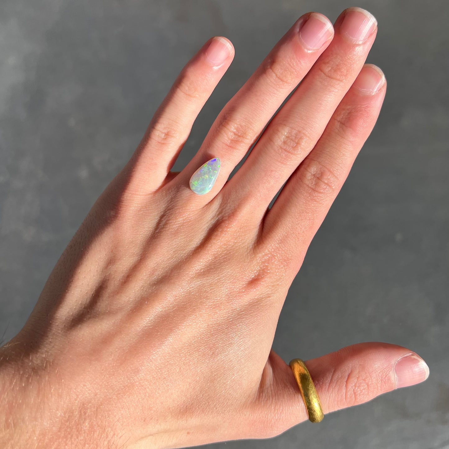 A pear shaped light opal stone from Lightning Ridge, Australia.