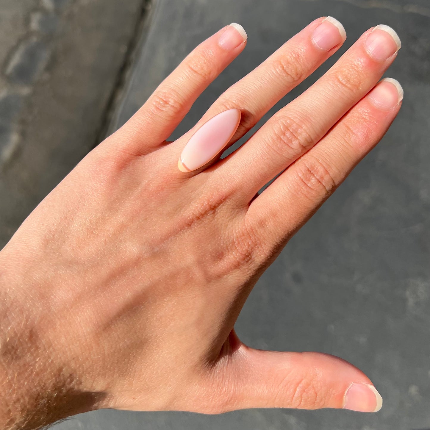 A loose, marquise cabochon cut pink common opal from Peru. The opal has no play of color.