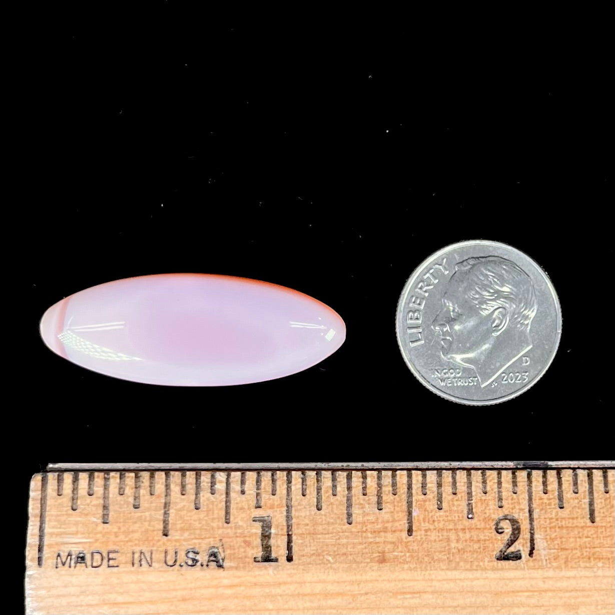 A loose, marquise cabochon cut pink common opal from Peru. The opal has no play of color.