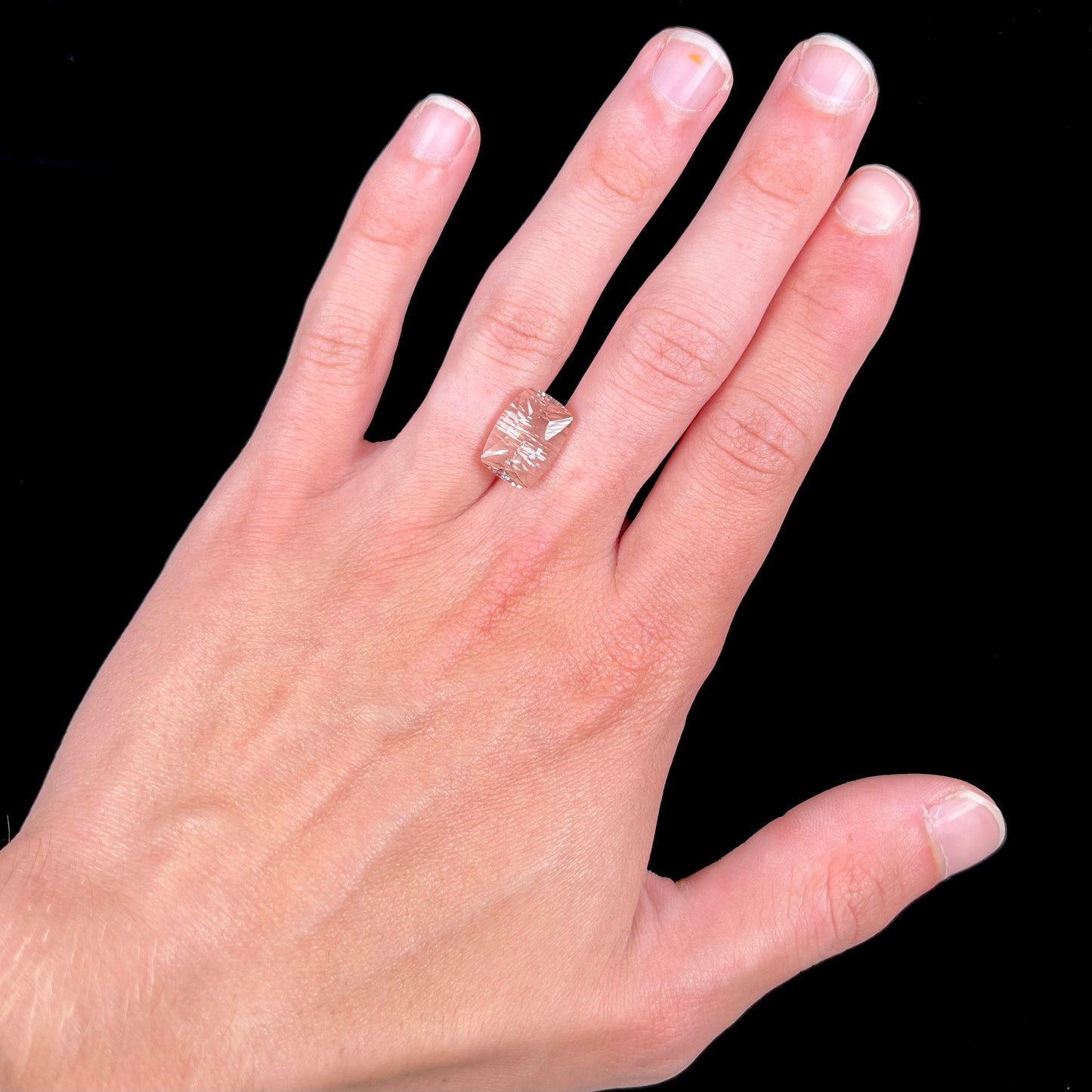 A loose, modified cushion cut pink morganite stone.