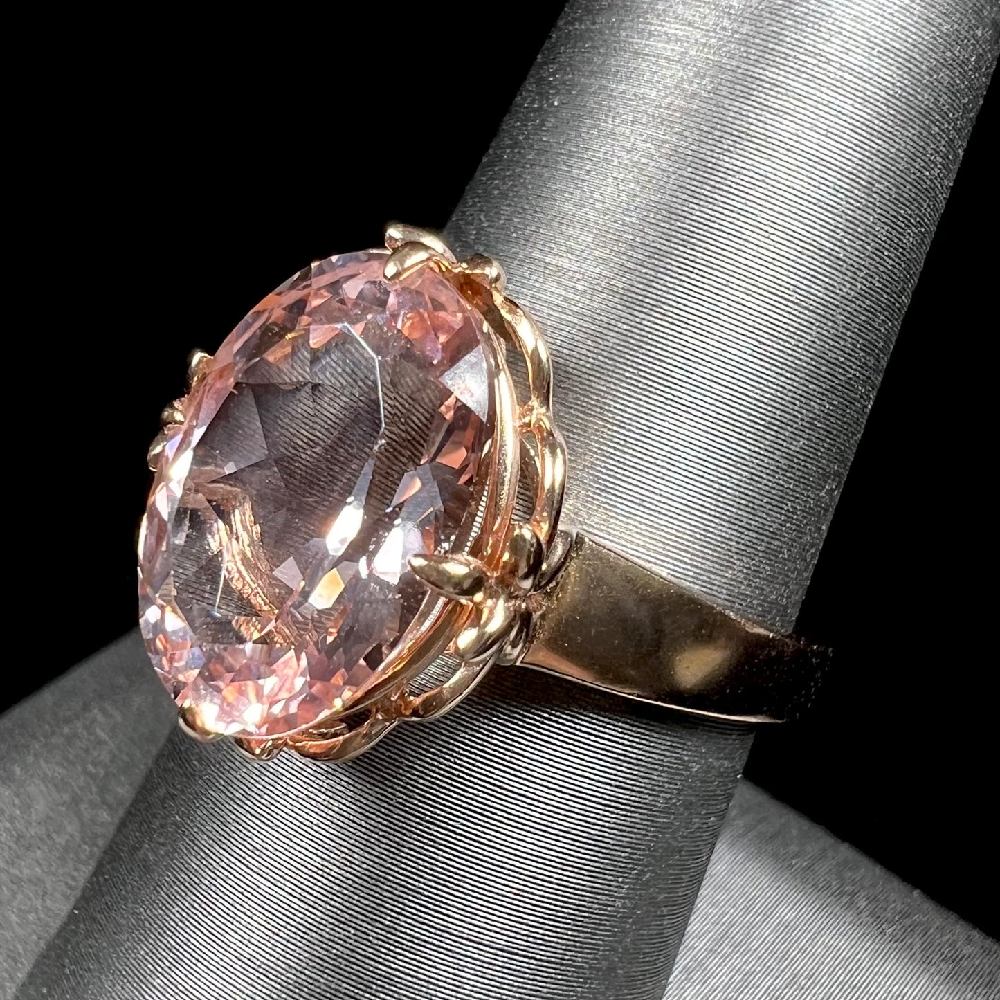 A ladies' rose gold solitaire ring set with an oval cut pink morganite gemstone.