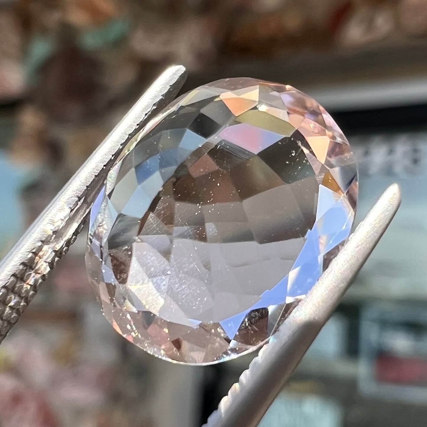A loose, faceted oval cut pink morganite gemstone.