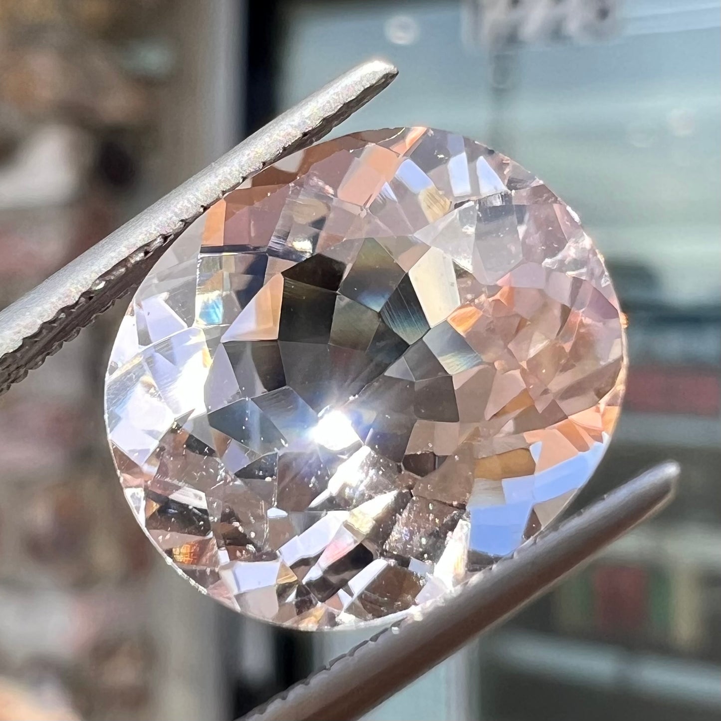 A loose, faceted oval cut pink morganite gemstone.