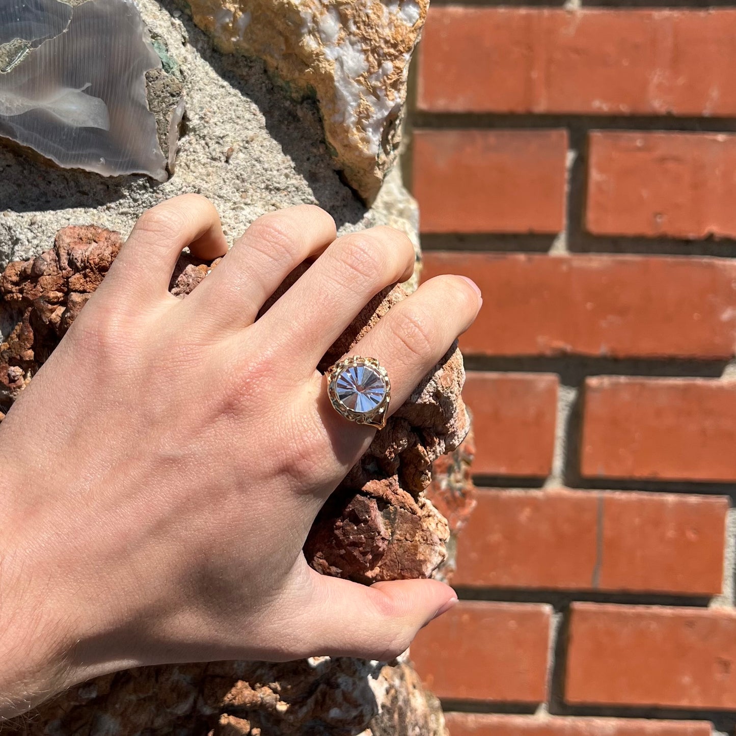 A ladies' yellow gold solitaire ring bezel set with a modified bud cut morganite gemstone.