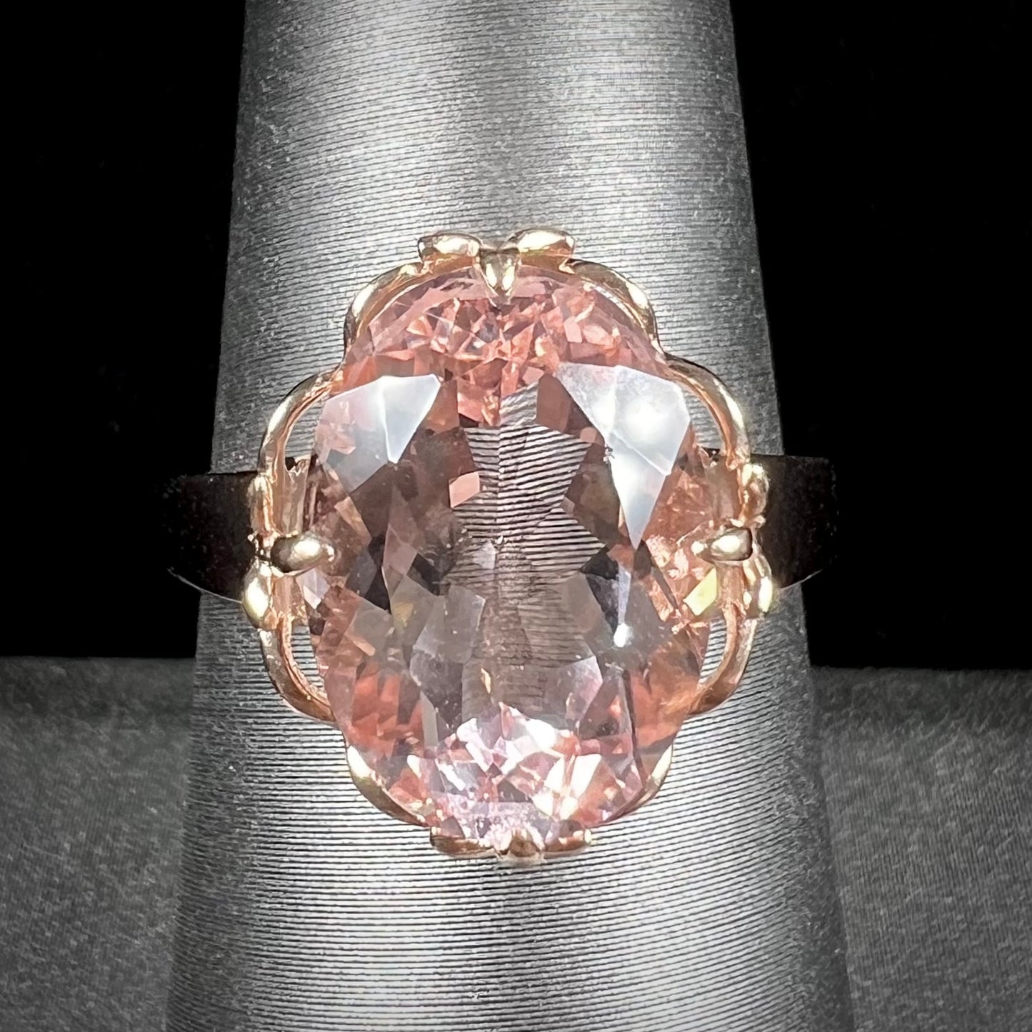 A ladies' rose gold solitaire ring set with an oval cut pink morganite gemstone.